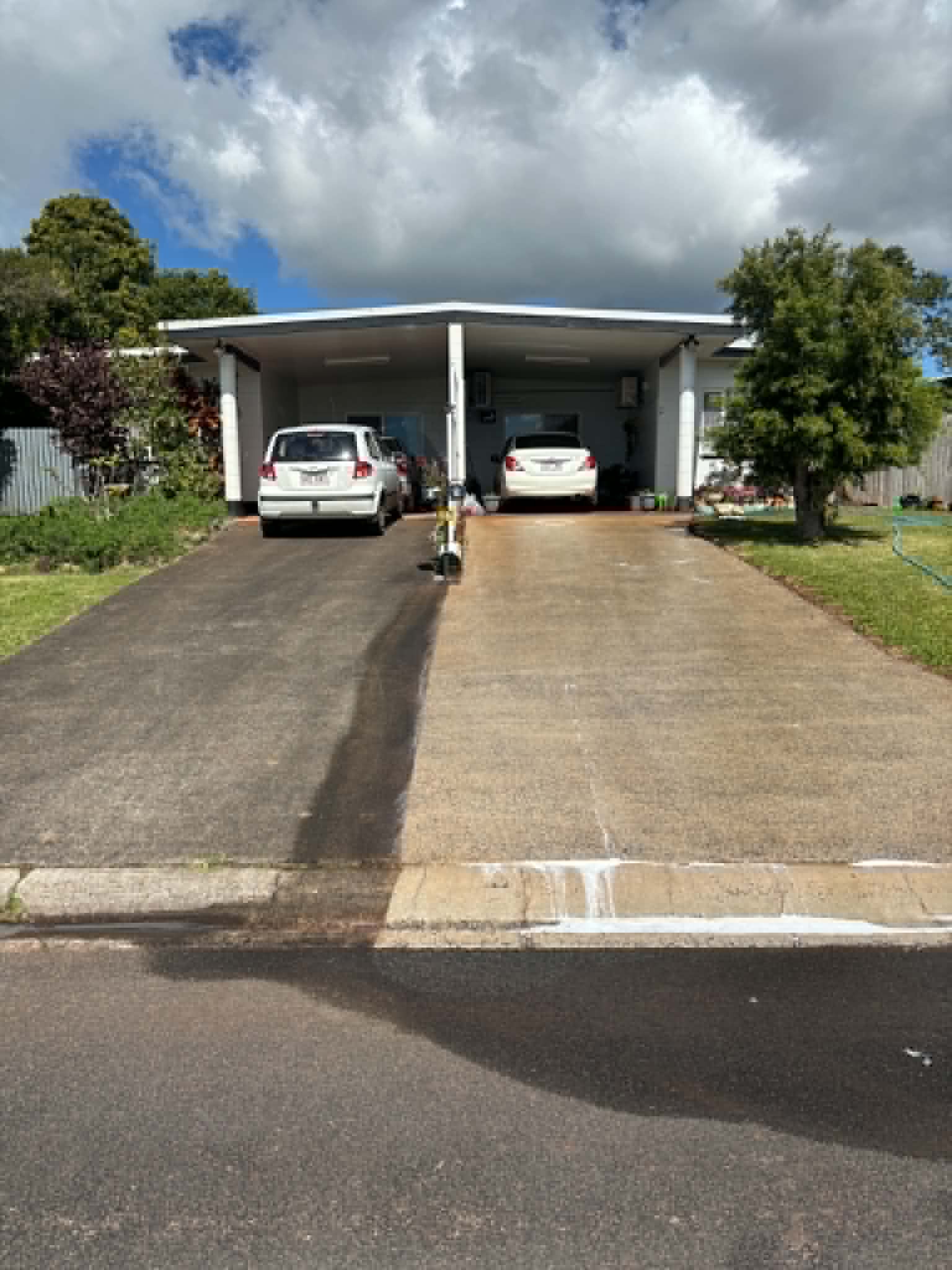 Driveway half pressure cleaned, half not, showing the contrast